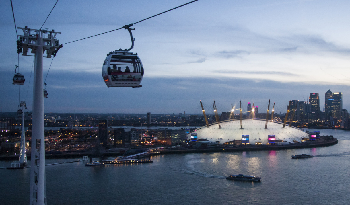 Night view over the Emirates Air Line, Uber Boat by Thames Clippers and The O2.